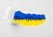 Free Ukraine. Ukrainian flag with phrase, view through torn white paper