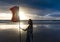 Free woman enjoying freedom feeling happy at beach at sunset. Beautiful serene relaxing woman in pure happiness and