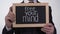 Free your mind phrase on blackboard in businessman hands, creative approach