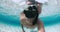 Freediver in diving mask make selfie underwater over sandy sea bottom in blue ocean. Activity vacation in tropical sea