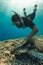 Freediver man with hawksbill turtle, underwater photography.