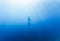 Freediver Swimming in Deep Sea With Sunrays
