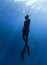 Freediver Swimming in Deep Sea With Sunrays