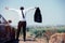 Freedom African businessman take off suit and standing on top of mountain with car