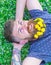 Freedom concept. Bearded man with dandelion flowers in beard lay on meadow, grass background. Man with beard on smiling