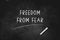 FREEDOM FROM FEAR written with chalk on blackboard icon logo design vector illustration