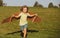 Freedom kids, boy playing to be airplane pilot, funny guy with cardboard wings as an airplane.