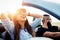 Freedom of the open road.Young Couple Driving Along Country Road In Open Top Car