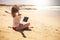 Freedom for smart working and digital nomad people lifestyle - happy free woman sitting on the sand beach work with 5g internet