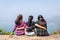 Freedom traveler group of woman sitting on mountain and embrace enjoying