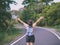 Freedom traveler woman standing with raised arms and enjoying a beautiful nature