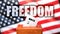 Freedom and voting in the USA, pictured as ballot box with American flag in the background and a phrase Freedom to symbolize that