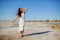 Freedom young asian woman in white dress with long hair in the wind on beach.