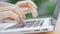 A freelance girl is typing a letter about work on the laptop keyboard. Close-up of a woman& x27;s fingers typing on a