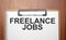freelance jobs text on white paper on the wood table