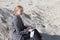 freelance and remote work.business woman in stylish business suit with laptop sitting in desert sand. Female student