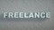 Freelance - Sign on White Brick Wall background - 3D illustration