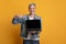 Freelance Websites. Positive Middle-Aged Woman Pointing At Laptop With Black Screen