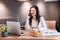 Freelance woman using laptop while sitting at home. Young woman sitting in kitchen and working on laptop. Pretty female