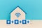 Freelance. Work from home. Online distance working. Stay home. Wooden house with wifi sign, cubes with person symbols