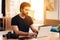 Freelancer bearded man typing at laptop sitting at desk.