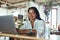 Freelancer. Business Woman Working On Laptop Remotely At Cafe. Fashion Girl In Glasses Sitting In Restaurant And Typing Something