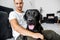 freelancer guy sitting at home working with a dog in an embrace, black labrador.