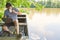 Freelancer man on laptop pc in a boat on the lake