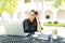 Freelancer Using Headphones And Laptop At Table In Garden