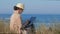 Freelancer woman taxting in her notebook on beach