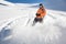 Freeride snowboarder sliding down the mountain slope