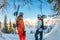 Freerider man and woman is standing on the mountainside in a helmet and with a backpack and looks into the distance