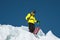 A freerider skier in complete outfit stands on a glacier in the North Caucasus. Skier preparing before jumping from the