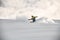 Freerider on a snowboard slipping on a snowy mountain side