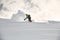 Freerider on a snowboard slipping on a snowy mountain side