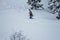 Freerider snowboarder climbs into a snowy mountain