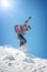 Freerider snowboarder jump from hill with snowboard and make splash