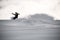 Freerider in sportswear sliding on a snowboard in mountains