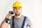 freestanding craftsman construction worker assembler with drilling machine - friendly worker in work clothes on white background