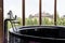 Freestanding glossy baththub with garden view