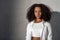 Freestyle. African girl in white outfit standing isolated on gray serious close-up