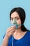 Freestyle. Chinese woman in oxygen mask standing  on grey breathingconcerned close-up