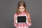 Freestyle. Girl standing on grey looking at screen of digital tablet excited close-up