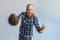 Freestyle. Mature man standing on grey catching ball shouting cheerful close-up