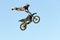 Freestyle motocross rider performs the trick in jump at fmx competitions