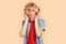 Freestyle. Teen blond boy in headphones standing isolated on color listening music cocentrated