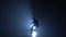 Freestyler against blue spotlight with haze making tricks. Slow motion