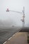 Freeway and intersection with traffic lights in dense fog