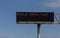 Freeway Sign advising of a child abduction against a blue sky