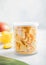 Freeze dried mangoes for cereal in plastic jar on light background